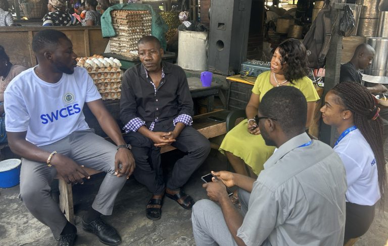 Community sensitization session on the Single Window Citizens Engagement Service, with facilitators engaging residents on access to government services (SWCES) and the Right to Information.